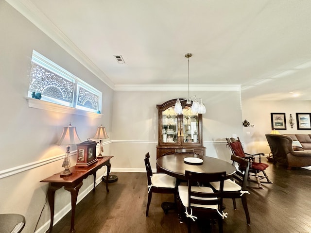 dining room with baseboards, visible vents, dark wood-style flooring, and ornamental molding