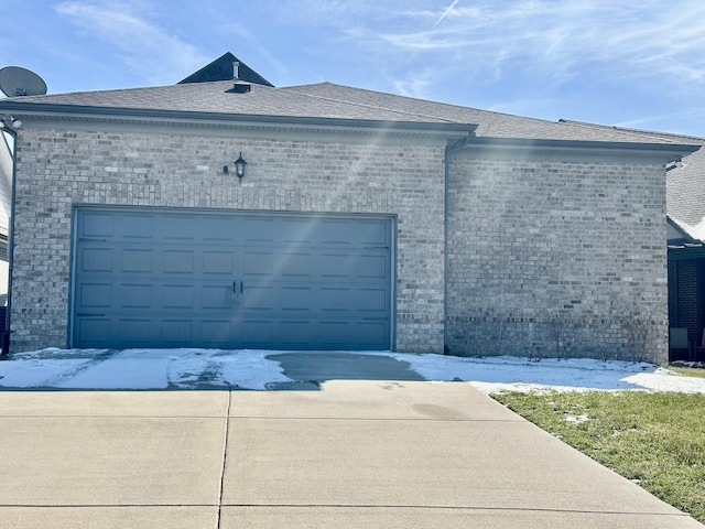 garage featuring concrete driveway