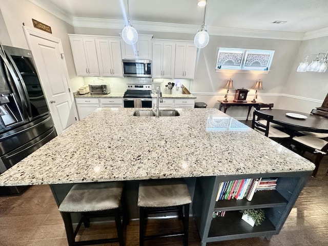 kitchen with a breakfast bar, crown molding, open shelves, appliances with stainless steel finishes, and white cabinets