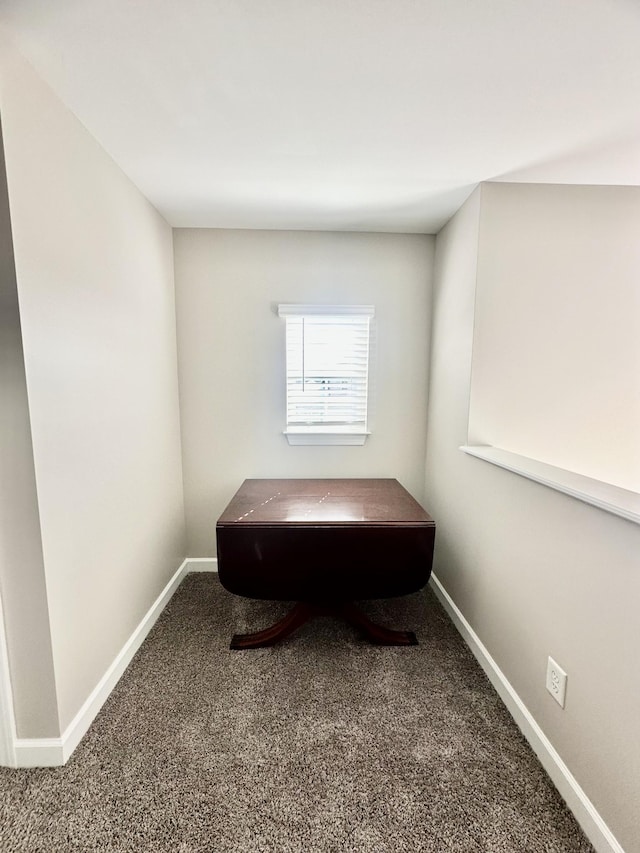 interior space with carpet flooring and baseboards