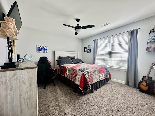 carpeted bedroom with ceiling fan, visible vents, and baseboards