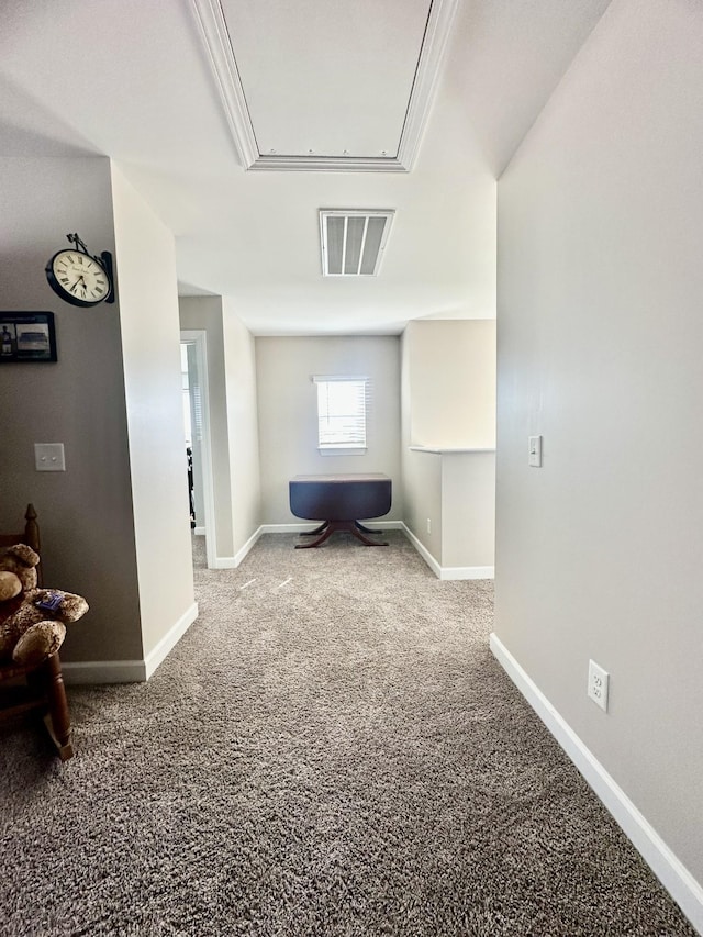 interior space featuring visible vents, carpet floors, attic access, and baseboards