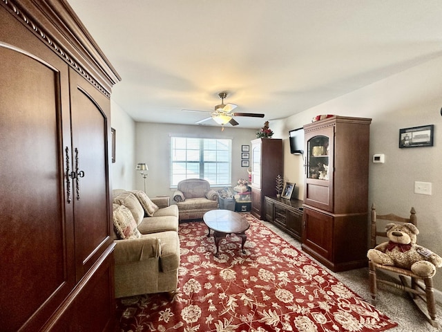 carpeted living room with a ceiling fan