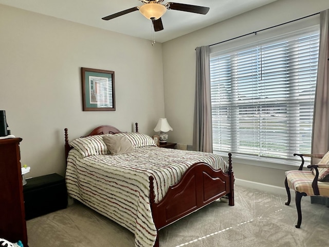 bedroom with carpet floors, baseboards, and a ceiling fan