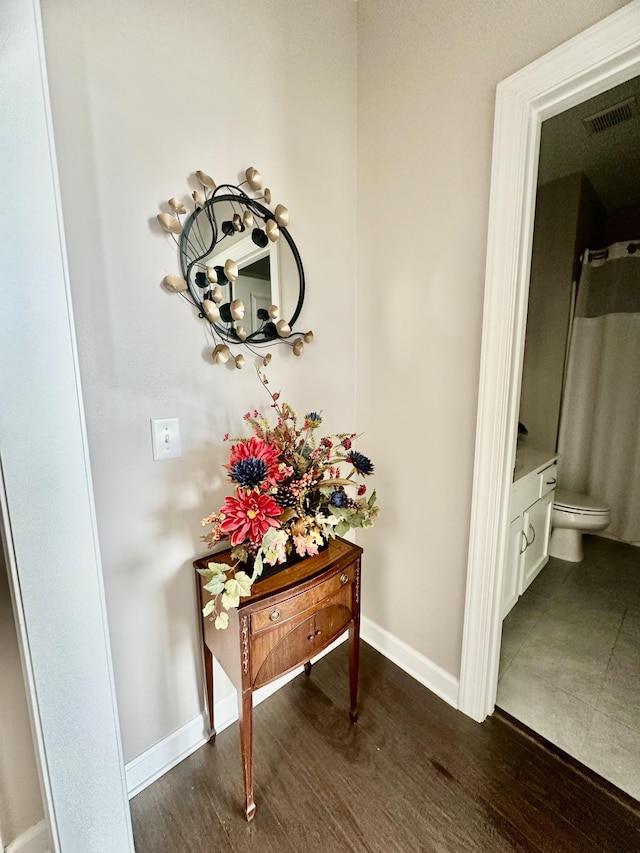 interior details featuring visible vents, baseboards, and wood finished floors