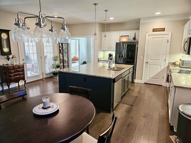 kitchen with dark wood-style flooring, a sink, dishwasher, black refrigerator with ice dispenser, and a center island with sink