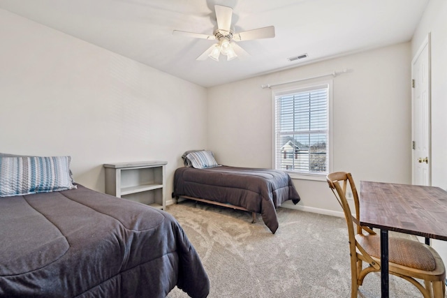 bedroom featuring baseboards, visible vents, a ceiling fan, and light colored carpet