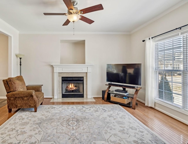 living room featuring light wood-style floors, baseboards, and ornamental molding