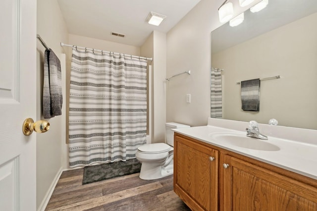 full bathroom featuring toilet, wood finished floors, visible vents, vanity, and a shower with curtain