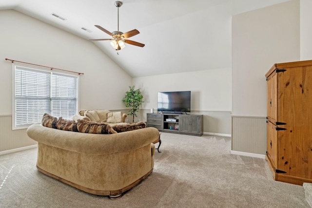 living area featuring a wainscoted wall, visible vents, a ceiling fan, and light colored carpet