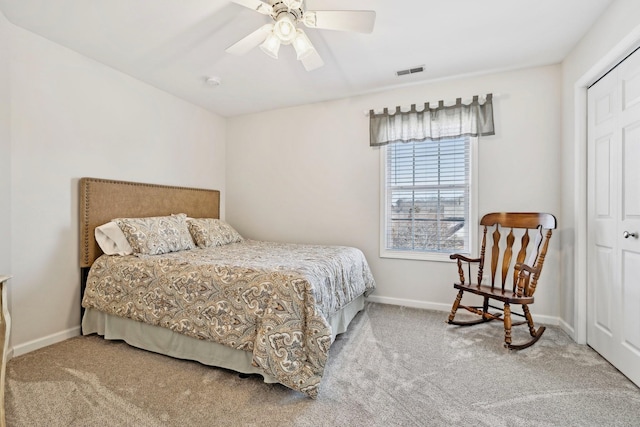 carpeted bedroom with ceiling fan, a closet, visible vents, and baseboards