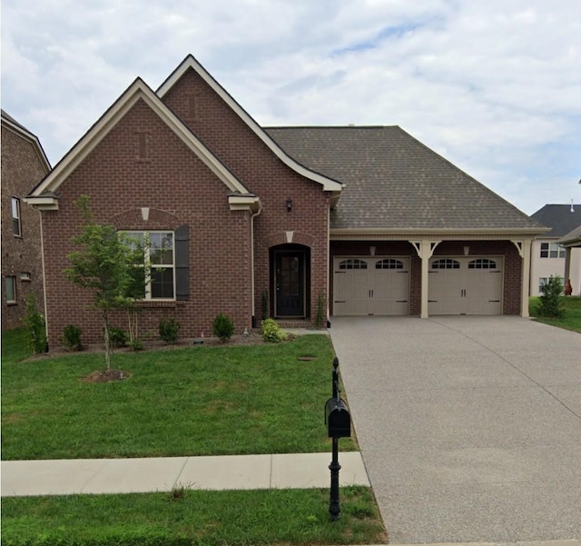 view of front facade featuring a garage, a front lawn, concrete driveway, and brick siding