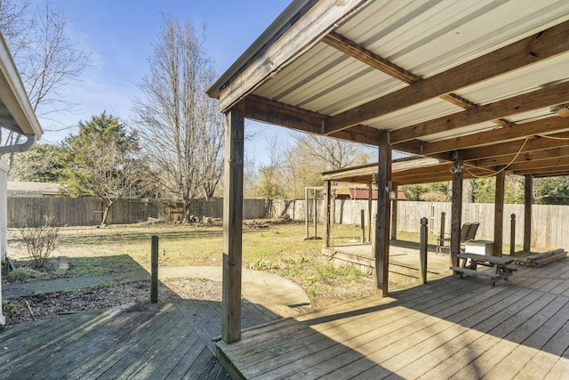 wooden terrace featuring a fenced backyard and a yard