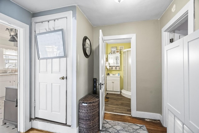 interior space featuring dark wood finished floors and baseboards