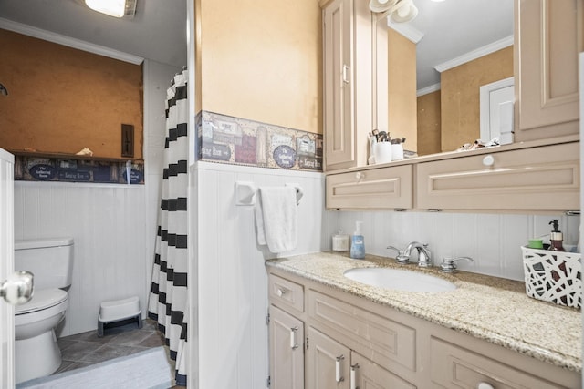 full bathroom with wainscoting, tile patterned floors, toilet, and crown molding