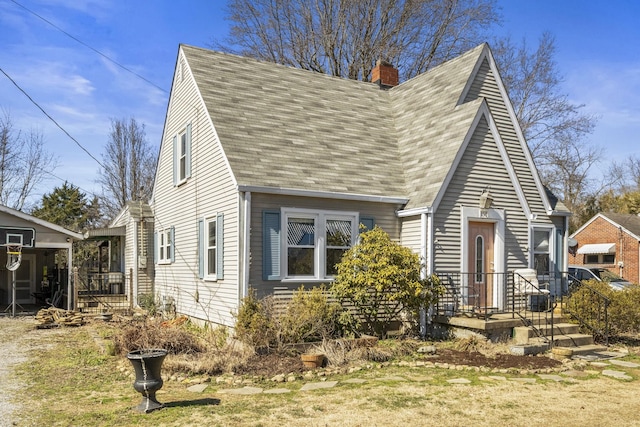 view of front of property featuring a shingled roof and a chimney