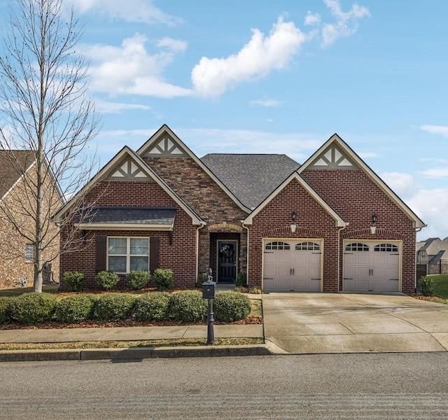 view of front of property featuring a garage, driveway, brick siding, and a shingled roof