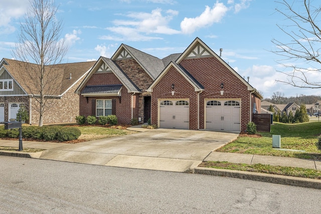 view of front of property with driveway, an attached garage, a front lawn, and brick siding