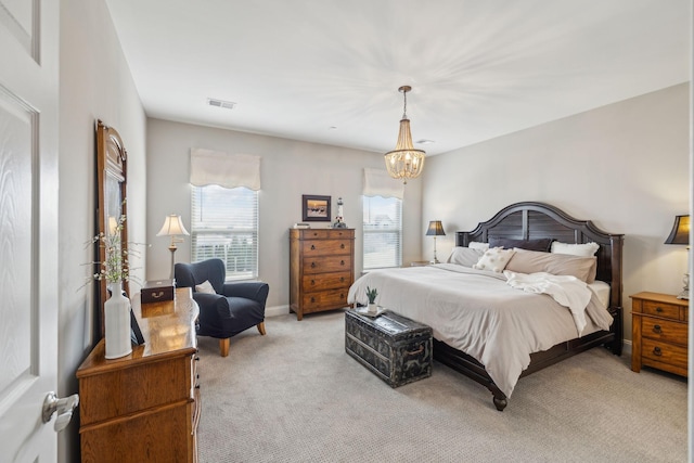 bedroom featuring light colored carpet, a notable chandelier, visible vents, and baseboards