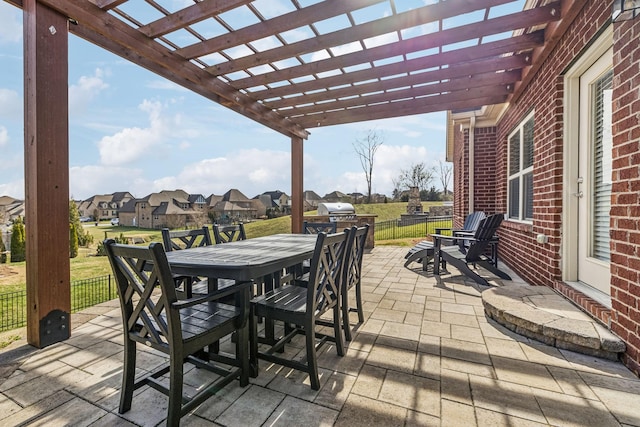 view of patio with a residential view, fence, outdoor dining area, and a pergola