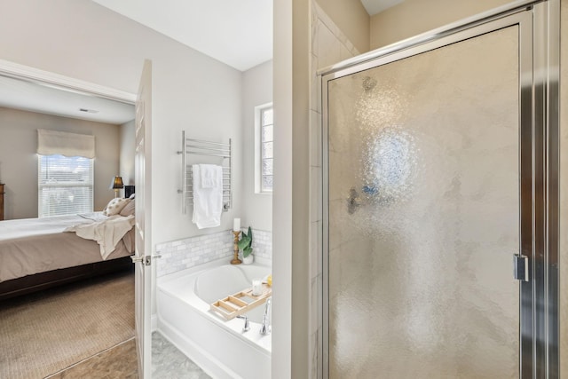 ensuite bathroom with a shower stall, a bath, and ensuite bathroom