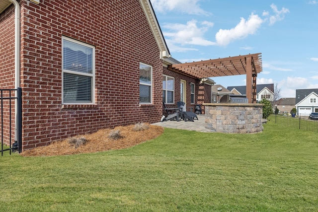 view of side of property with a yard, fence, a patio, and brick siding