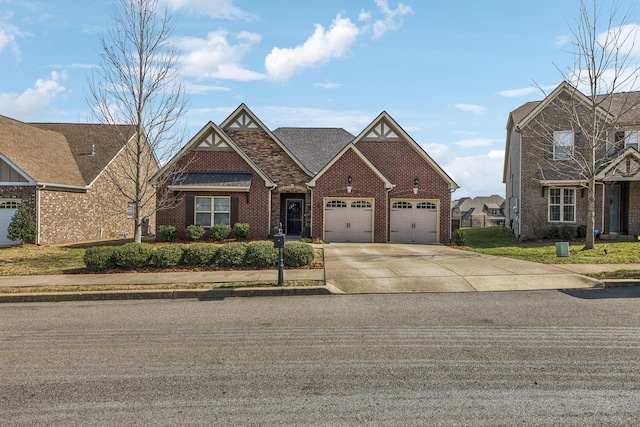 view of front of property featuring a garage, concrete driveway, and brick siding