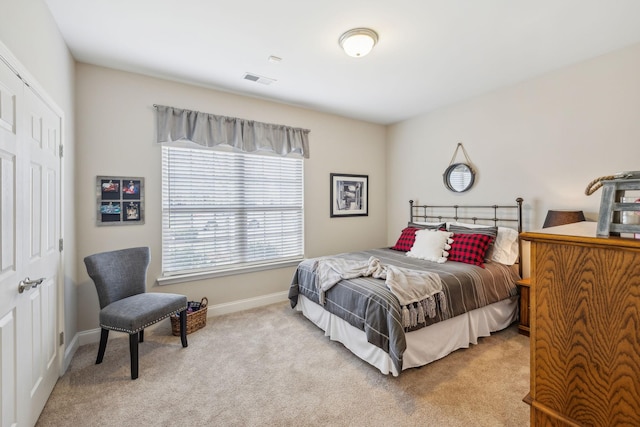 bedroom with visible vents, baseboards, and light colored carpet