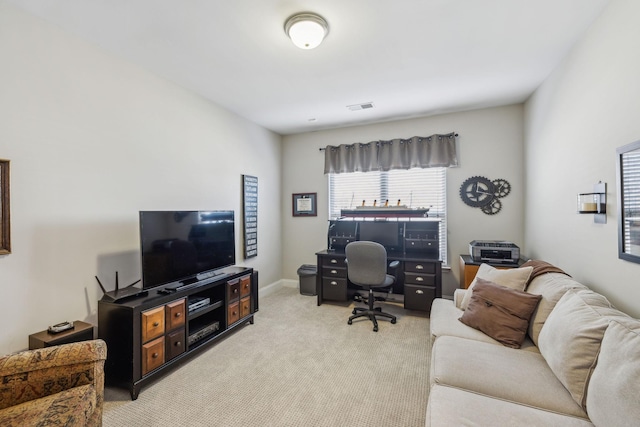 office area featuring light colored carpet, visible vents, and baseboards