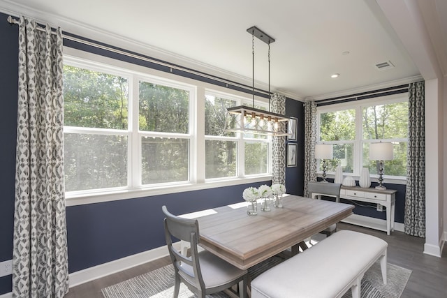 dining space featuring ornamental molding, dark wood-style flooring, visible vents, and baseboards