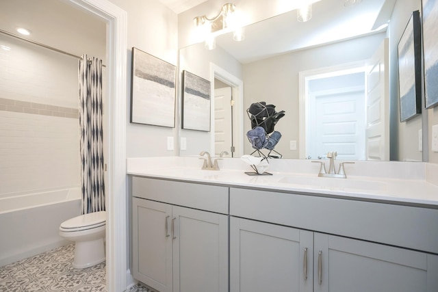 full bath featuring toilet, double vanity, shower / bath combo, and a sink