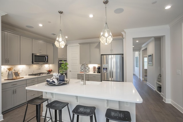 kitchen with light countertops, appliances with stainless steel finishes, and a large island