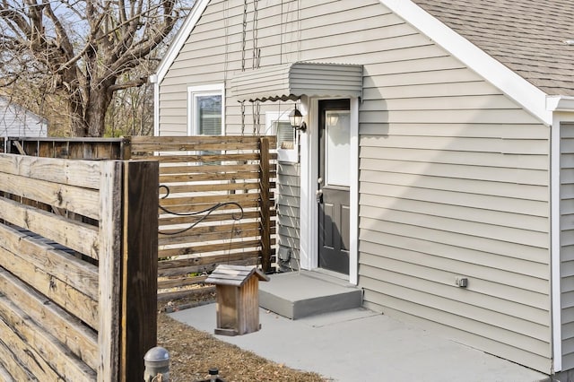 property entrance with a shingled roof