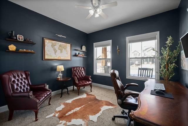 office with light colored carpet, a ceiling fan, and baseboards