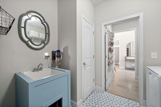 bathroom with vanity, baseboards, and tile patterned floors