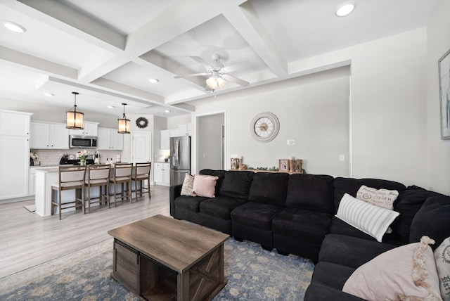 living area with recessed lighting, coffered ceiling, beam ceiling, and light wood-style floors