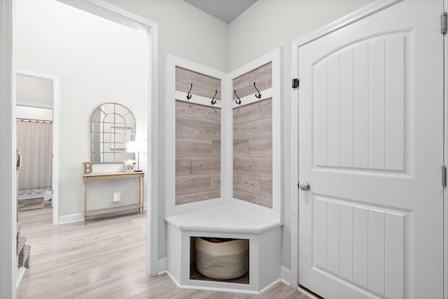 mudroom featuring light wood-style floors and baseboards