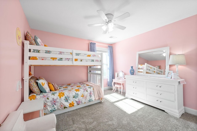 carpeted bedroom featuring a ceiling fan, visible vents, and baseboards