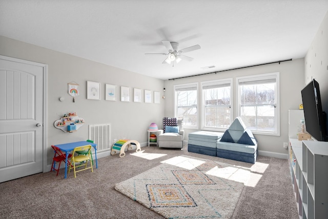 playroom with carpet floors, baseboards, visible vents, and a ceiling fan