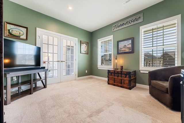 living area featuring french doors, carpet, visible vents, and baseboards