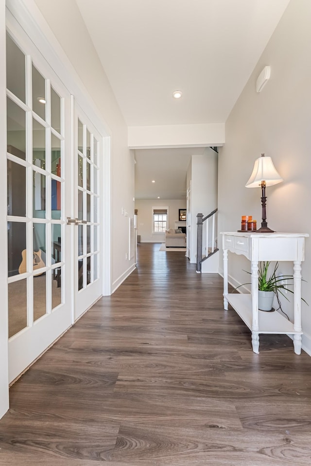 hall with baseboards, stairway, wood finished floors, and recessed lighting