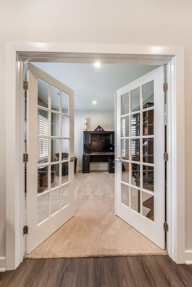 entryway featuring carpet floors, french doors, wood finished floors, and recessed lighting