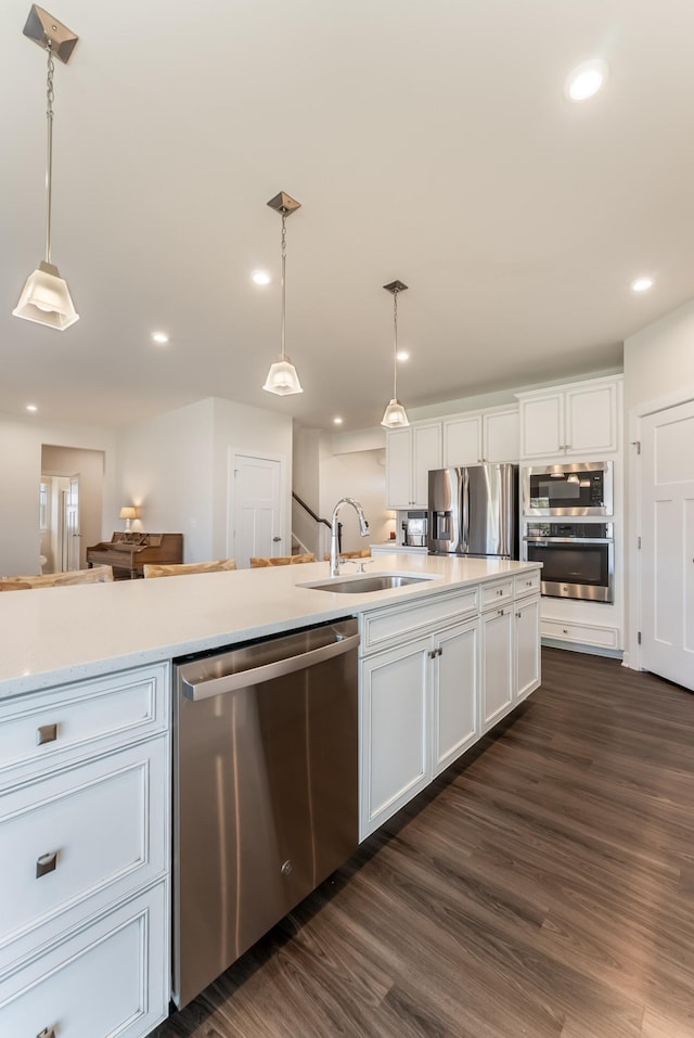 kitchen featuring recessed lighting, white cabinetry, light countertops, appliances with stainless steel finishes, and dark wood finished floors