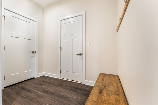 doorway to outside featuring dark wood finished floors and baseboards