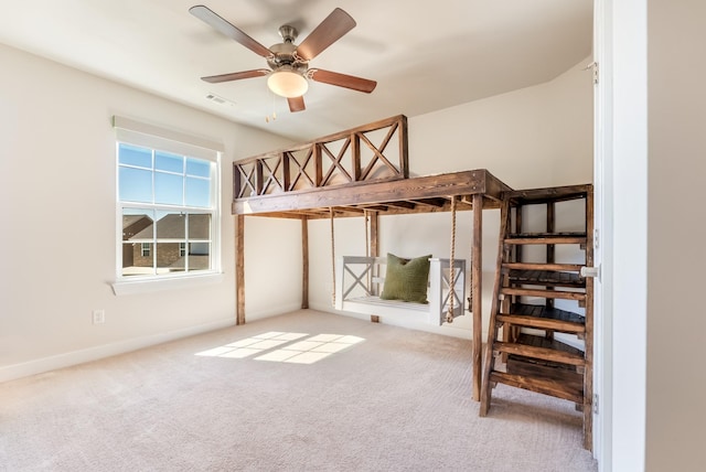 unfurnished bedroom featuring carpet, visible vents, ceiling fan, and baseboards