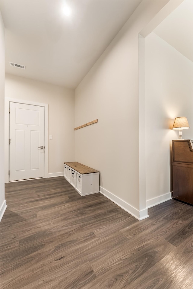 interior space featuring visible vents, dark wood finished floors, and baseboards