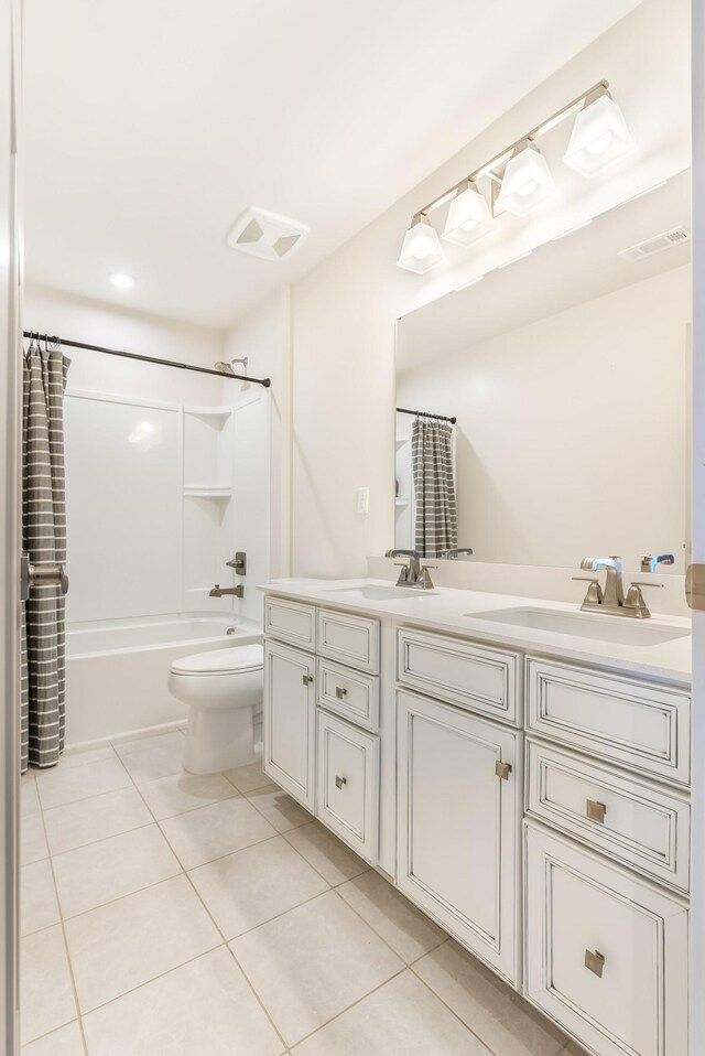 full bath with double vanity, tile patterned flooring, visible vents, and a sink