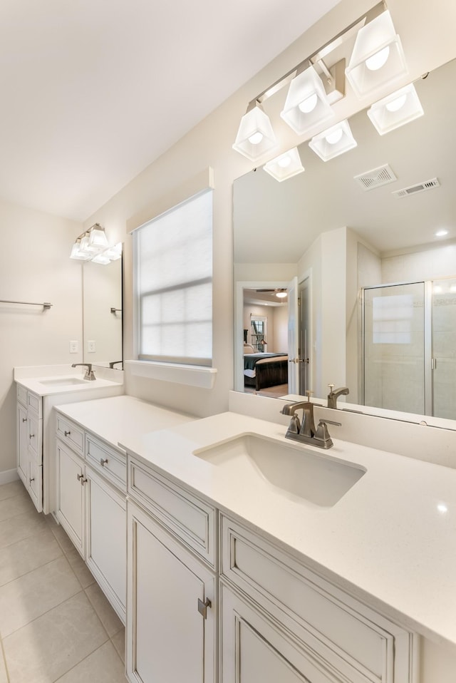 full bath featuring a shower stall, connected bathroom, visible vents, and a sink