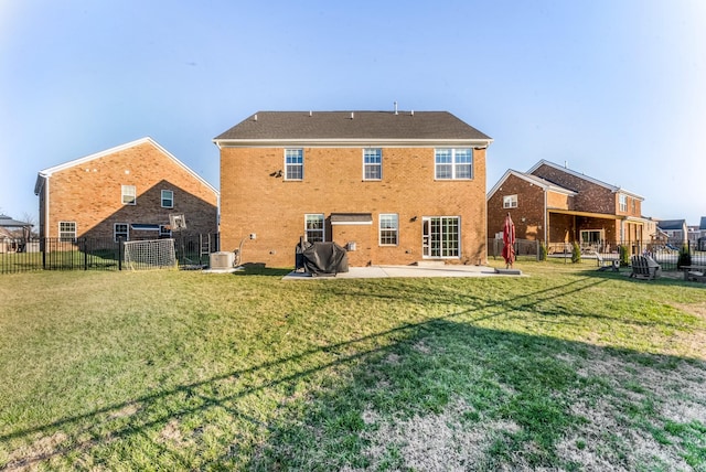 rear view of house with central AC unit, fence, a lawn, and brick siding