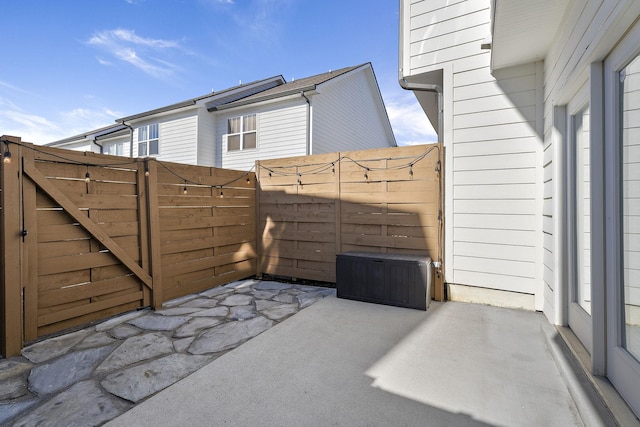 view of patio featuring a gate and fence